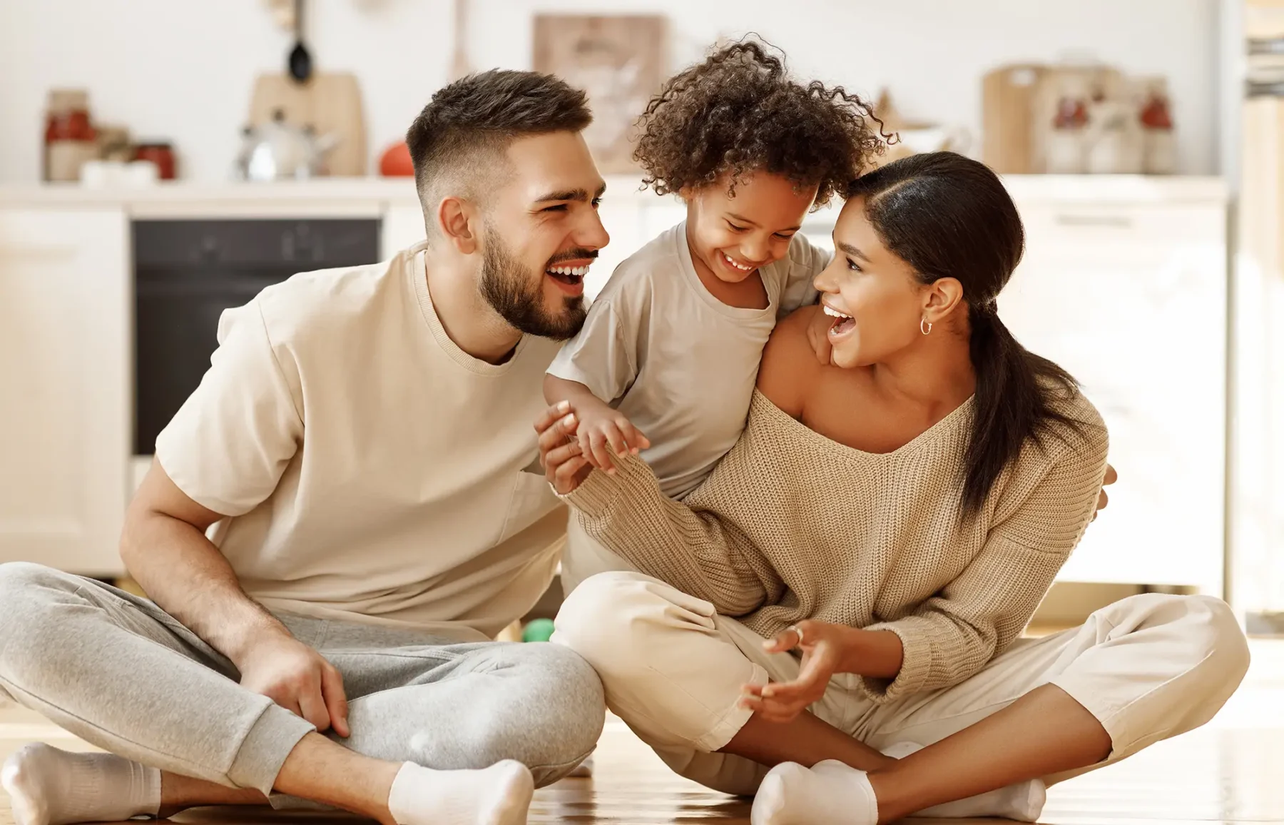young family smiling and laughing together