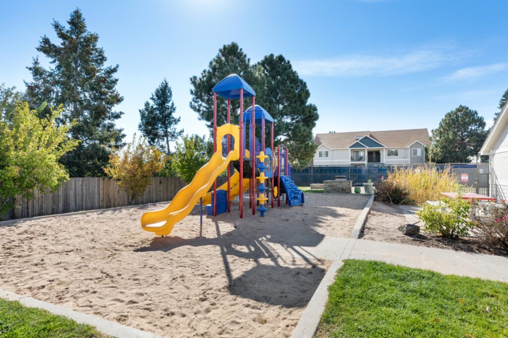 Playground with climbing and slides at Belmar Villas apartments for rent in Lakewood, CO