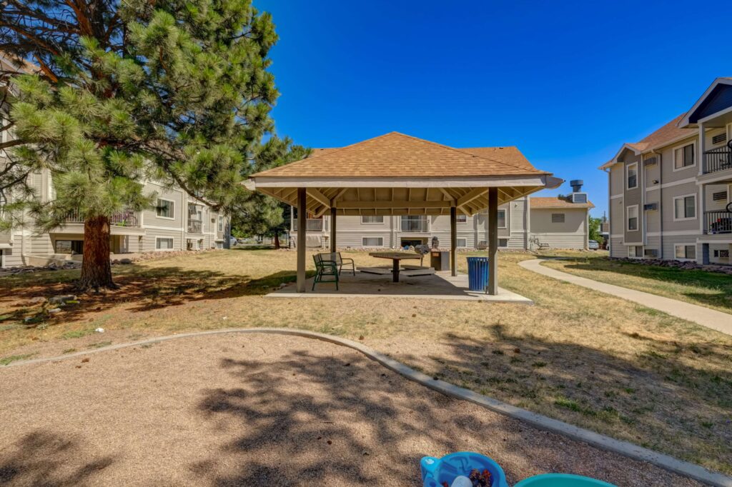 Exterior with lots of green space between buildings and large trees