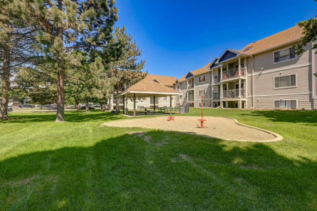 Exterior with lots of green space between buildings and large trees