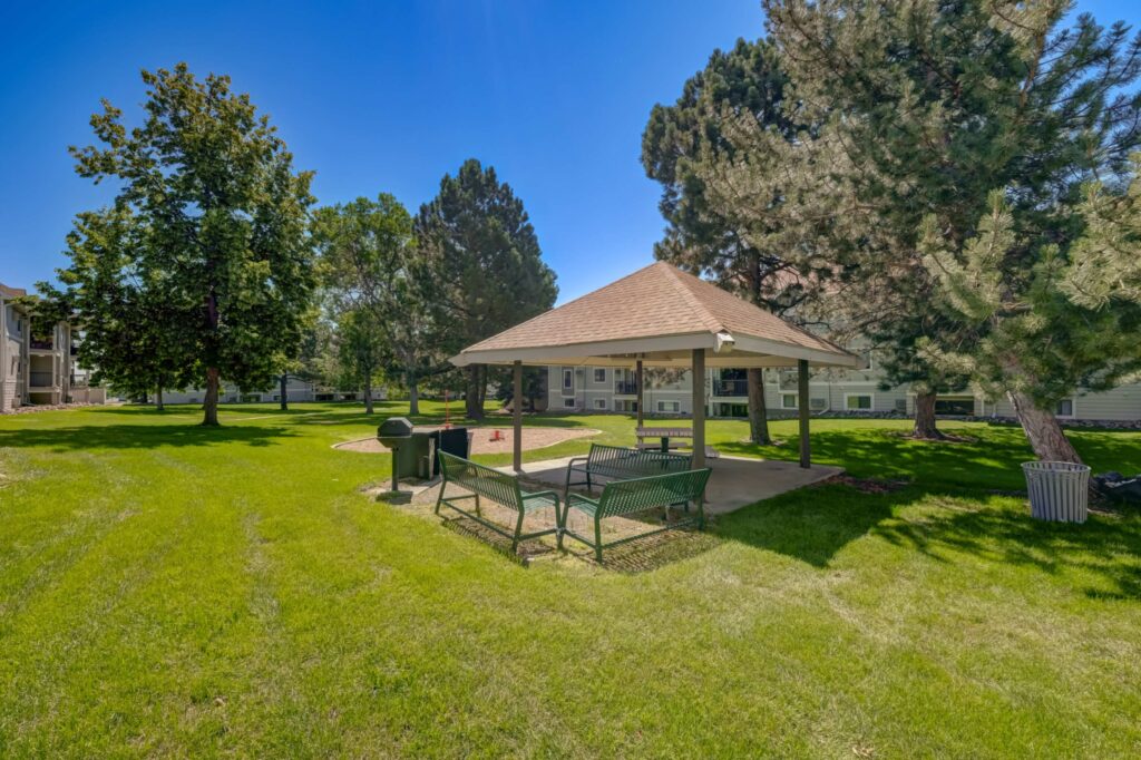 Exterior with lots of green space between buildings and large trees