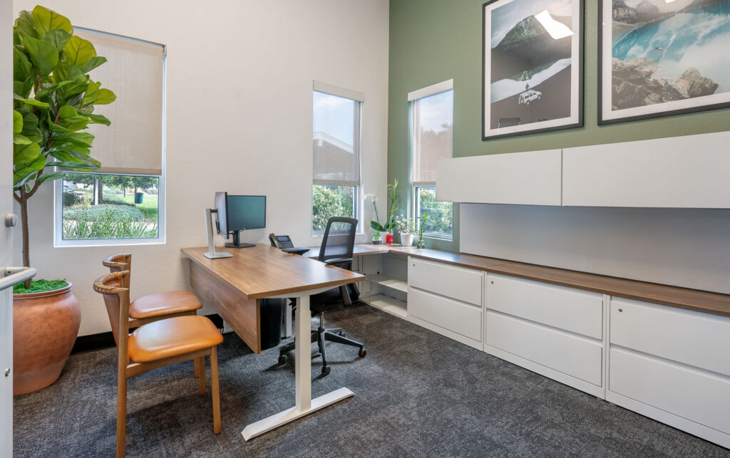 Leasing center office with desk and computer with office chairs and a filing cabinet system